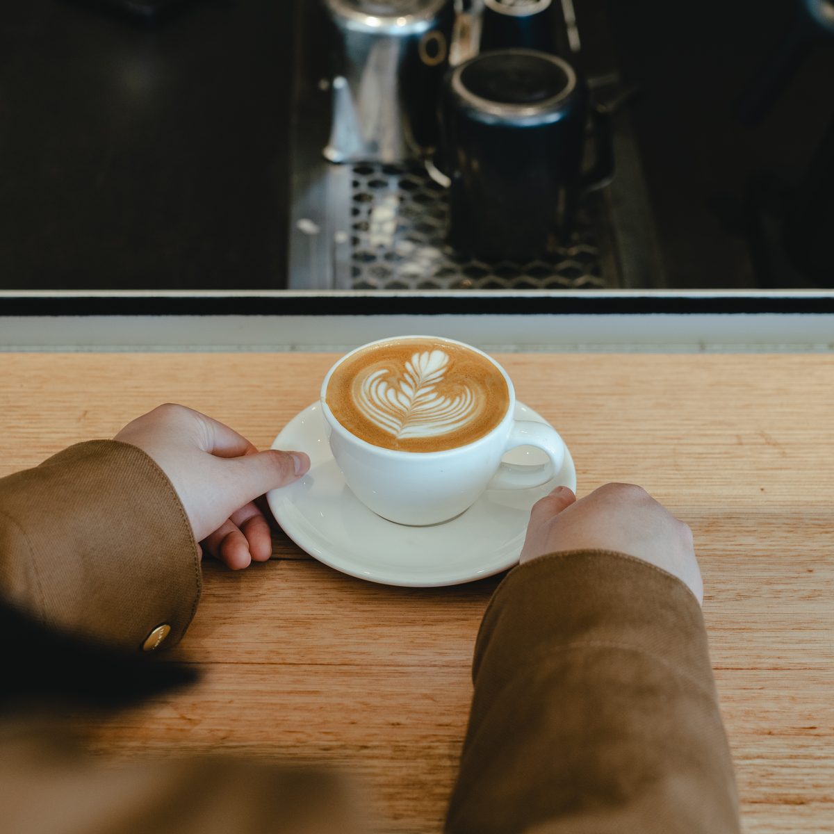 A latte in a white cup and saucer